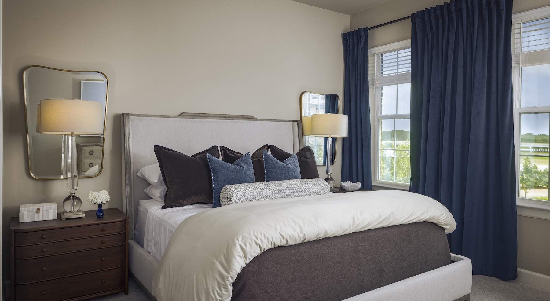 bedroom with bed lamps and windows