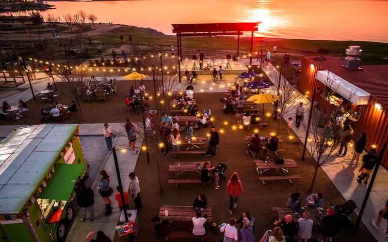 a group of people at an event outdoors at dusk